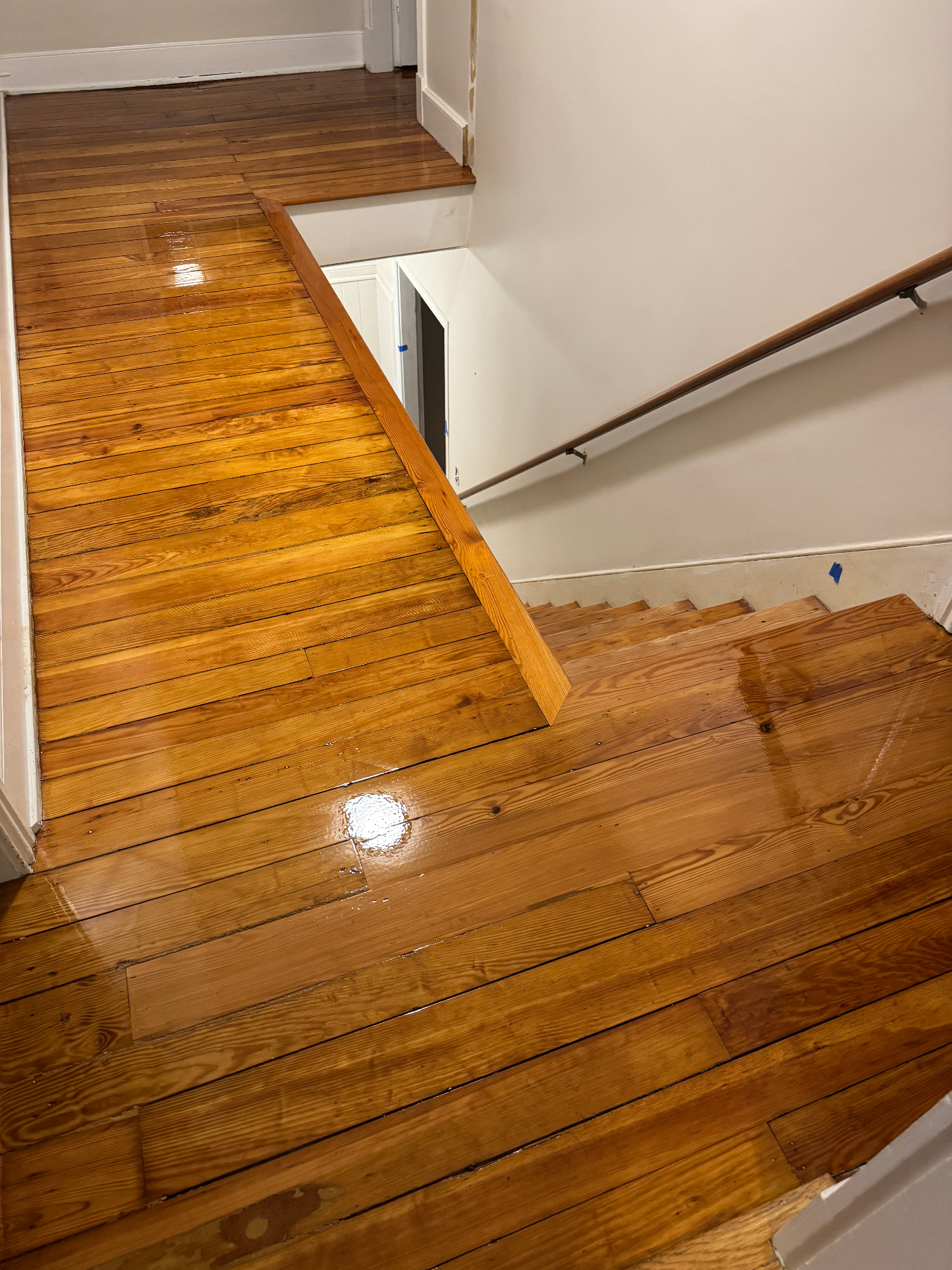 Refreshed glossy hardwood floor after dustless sanding